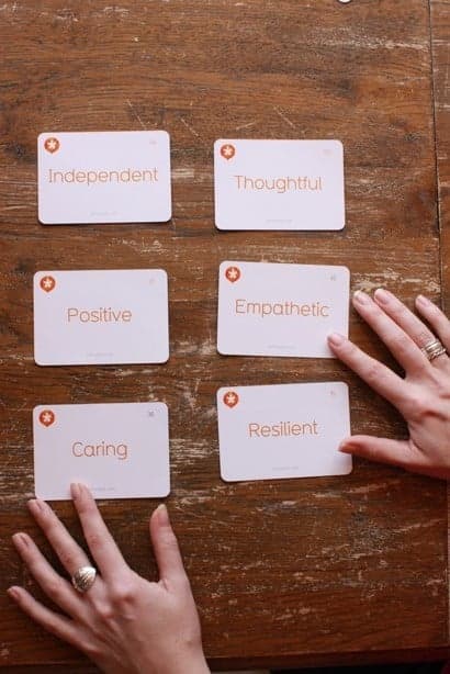 Somebody arranging life skill cards.