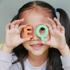 Child holding E and Q