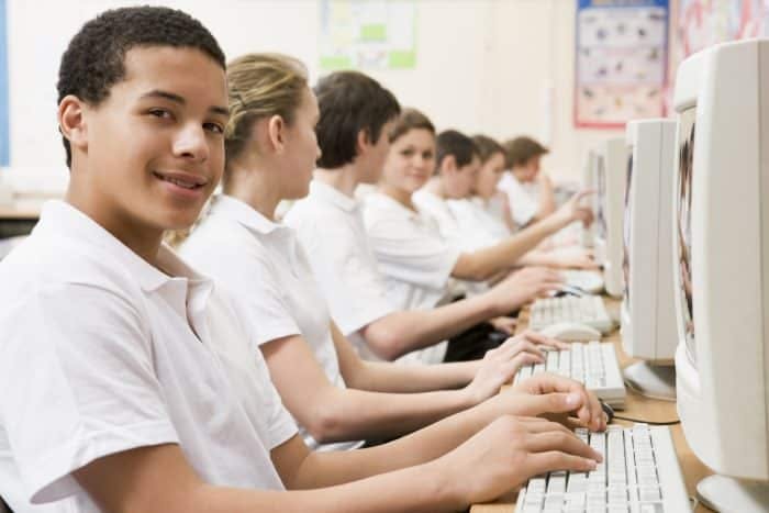 bunch of kids in front of computers