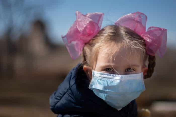 girl with pink bows and mask